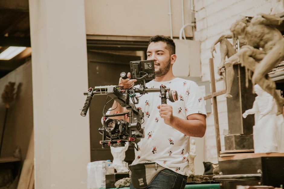 Videographer behind camera capturing a wedding moment